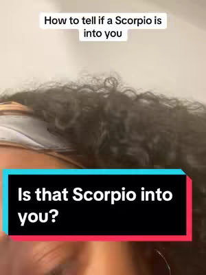 The cover image features a close-up shot of a person's face with dark curly hair, focusing on the eyes and the text overlay. A black box with a turquoise outline reads "Is that Scorpio into you?" at the bottom, and a white text on top reads "How to tell if a Scorpio is into you". The lighting appears to be soft, and the background fades into a neutral color.