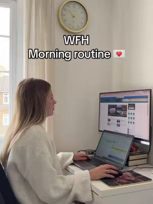 A woman sits at a desk in front of a computer and laptop, in a well-lit room. The words "WFH Morning routine" are overlaid on the image.