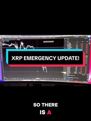 A screen displaying financial data with a text overlay reading "XRP EMERGENCY UPDATE!". The screen shows lines and graphs, indicating market analysis. The color scheme is dominated by blues and grays.