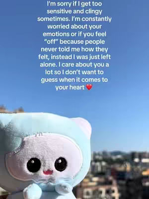 The image features a plush toy in the foreground with a blue sky background. The plush toy is a white and blue figure with large black eyes and a pink mouth. Text is overlaid at the top of the image in black text that describes a message of vulnerability and care.