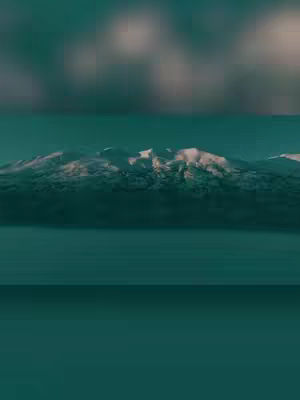An abstract, blurred landscape. The top portion is a blurry sky of white and shades of green. Below, a mountain range with snowy peaks is visible, with a teal, calm body of water in the bottom area reflecting the sky.