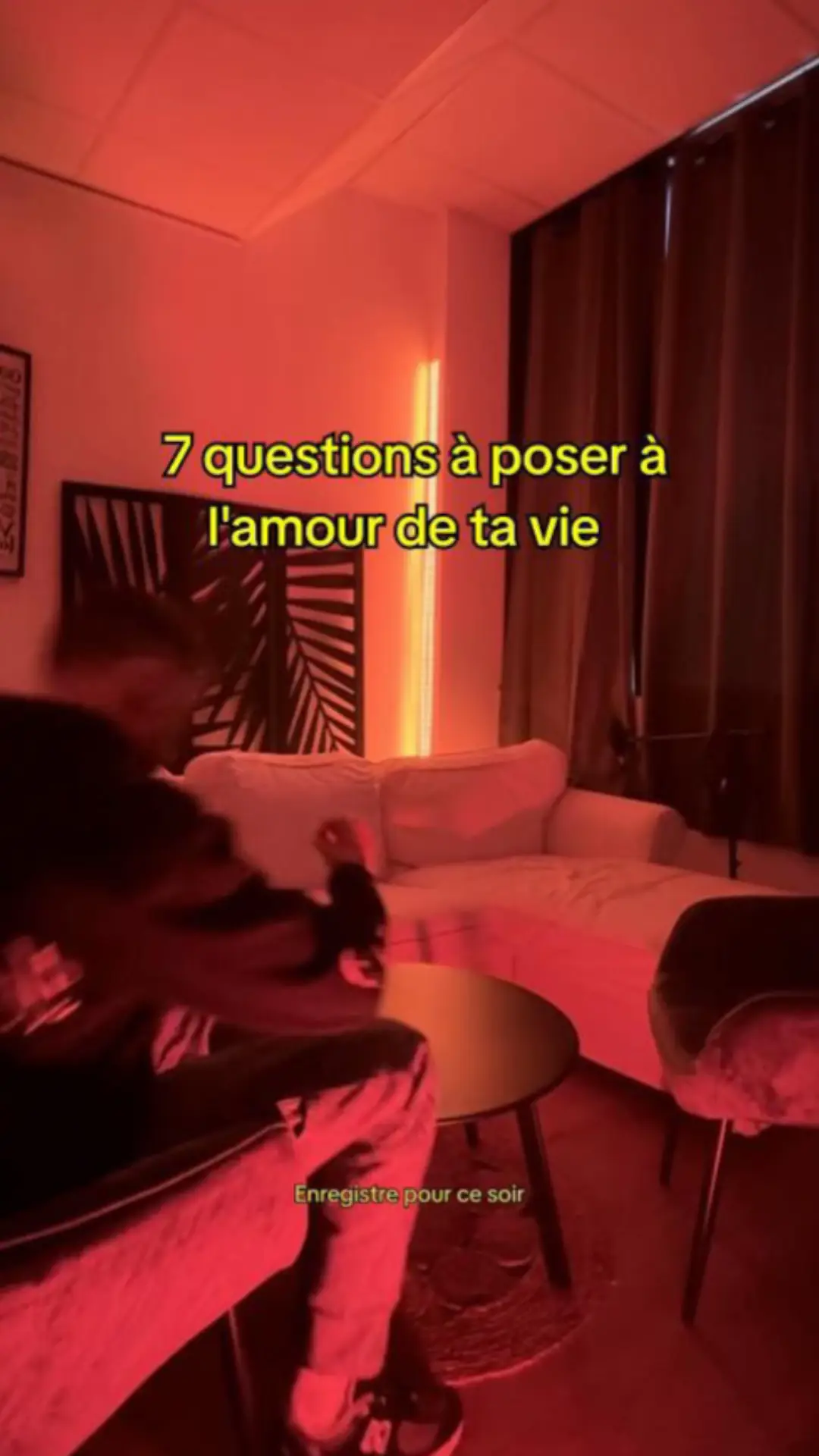The cover image shows a room bathed in red light. A blurred figure is in the foreground, suggesting movement. In the background, there is a white couch and a table. Text overlays the image, providing context or the video's hook.