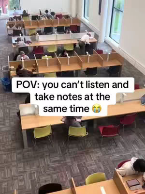 An overhead shot of a library with several rows of study desks. People are sitting at the desks, presumably studying. Text overlays at the bottom.
