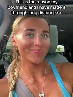 A woman with blonde hair in a braid smiles, looking at the camera. The background is slightly blurred, suggesting she's in a car. Text overlayed.