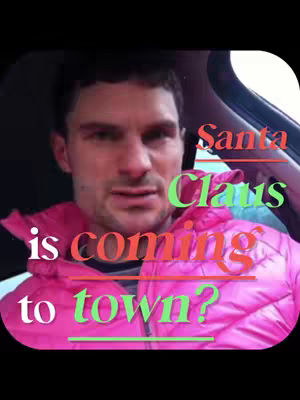 A selfie-style video cover, featuring a man seated inside a car with a visible part of the car's interior. The man is wearing a bright pink puffy jacket. Overlaid on the video are text elements in red and green, asking 'Santa Claus is coming to town?'. The background is blurred but shows the car. A close-up shot focuses on the man's face and the text overlay.