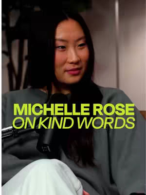 The cover image is a vertical shot featuring a woman with long dark hair. The image is well-lit, and the woman is centered in the frame, seated, and looking slightly to the side. The overlaying text, in a neon green font, reads "MICHELLE ROSE ON KIND WORDS."