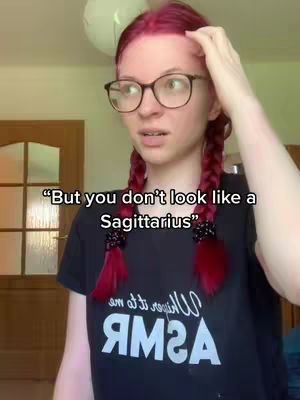 A young woman with red braids and glasses looks surprised, with text overlayed saying 'But you don't look like a Sagittarius'.