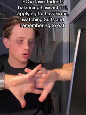 A young man with short brown hair is framed from the chest up, looking directly at the camera with a slightly distressed expression. The image has additional text in white overlay. He is wearing a black shirt. He has a laptop screen to his right and hands in a gesture of stress across the frame. The background appears to be a room.