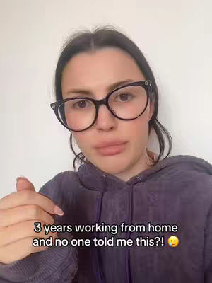 A woman with dark hair and glasses looks directly at the camera with a slightly concerned expression. Text is overlaid on the lower part of the image.