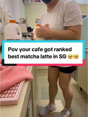 A person in a white shirt holding a container with an orange lid and a blue lid, stands to the left in front of a counter. The person wears a dark face mask and black shorts, and in front of them is a pink surface. The hook text is displayed in a rectangular text box overlaid.