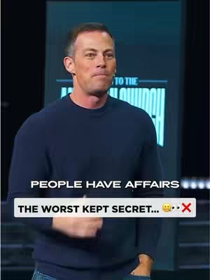 A man in a dark blue sweater stands on a stage or set with a blurred background. Text overlays are placed on the bottom half of the image. The man is looking slightly upwards, and the overall composition suggests a motivational or informative video.