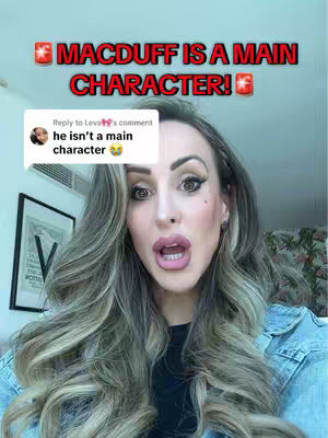 A woman with long, wavy blonde hair is in the center of the frame, her mouth open in an expression of surprise or excitement. Overlaid on the background in red text are the words 'MACDUFF IS A MAIN CHARACTER!' and a comment box that is partially visible.