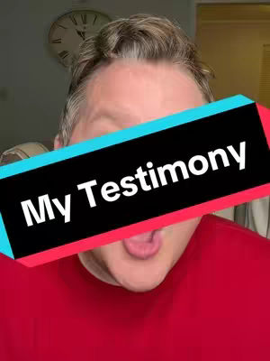 A man with short graying hair is facing the camera with his mouth open as if he's talking or singing. Covering his eyes is a horizontal banner with the text "My Testimony" in white. The colors are mostly red, black, and blue from the image.
