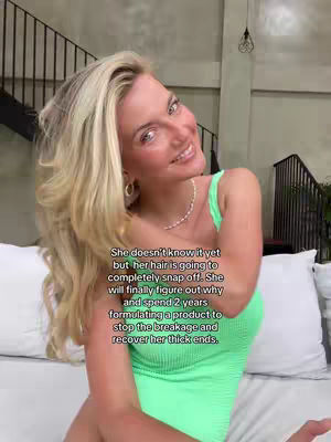 A young woman with long blonde hair smiles at the camera. She wears a green top and a necklace. Text overlays are present on the image.