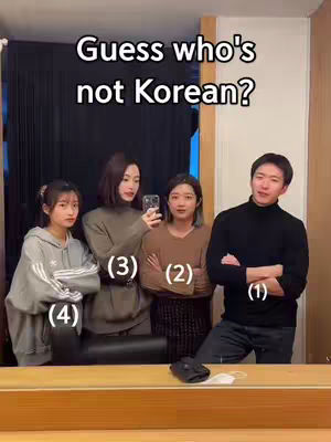 The image shows four people posing in a mirror, with text overlaid at the top. Three women and one man are standing close together. The text asks, 'Guess who's not Korean?' Each person is numbered in sequence from 1 to 4.