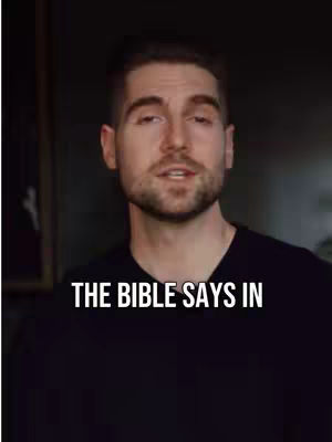A medium shot features a man speaking directly to the camera. The background is dark and out of focus, emphasizing the man. Overlayed on the bottom is the overlaid text.
