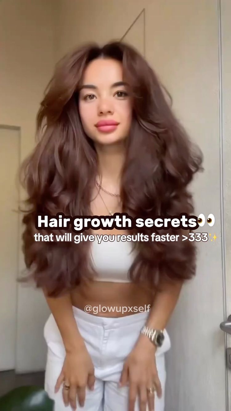 A woman with long brown hair is centered in the frame, wearing a white crop top and shorts. There is text overlayed on the image.