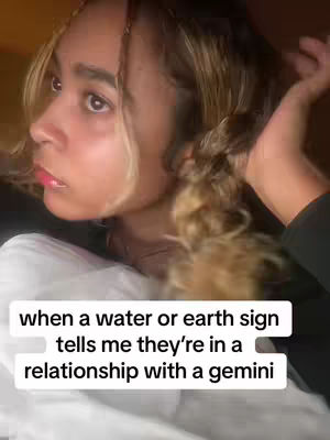A young woman gazes off to the side, her expression thoughtful. She has fair skin and light brown, wavy hair, with strands framing her face. The image is set against a dark background, with text overlayed at the bottom, providing content. The overall composition is intimate, with a focus on the young woman's face.