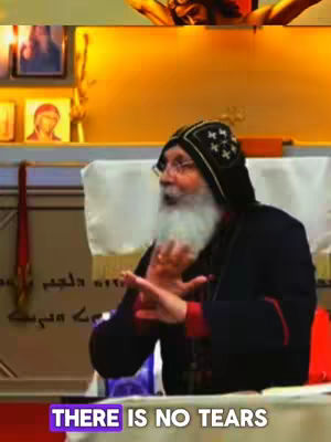 The video shows a man in religious attire, likely a bishop, speaking. He has a long white beard and is wearing a black hat. The background includes religious imagery and icons.