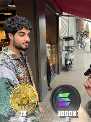 The cover image features a young man with dark, curly hair, positioned slightly left of the frame. He has a short beard and is wearing a patterned jacket over a dark shirt. He's holding a Bitcoin symbol over a background that appears to be an outdoor setting, near what looks like a shop entrance. On the right side, a Solana symbol is held. Text overlays are added to the foreground, likely promoting the Bitcoin and SOL.