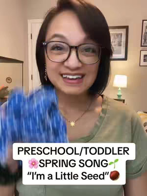A woman with short black hair and glasses smiles at the camera while holding a blue cloth, with a white bar at the bottom containing the video title and related images.