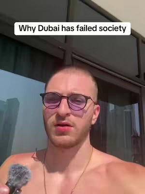 A man in front of a building is holding a microphone, looking at the camera, there is text on top that describes Dubai. 