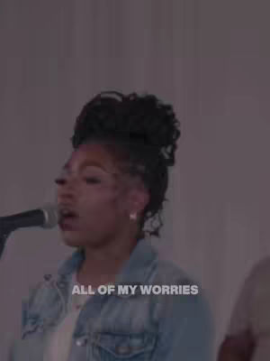 The cover image shows a woman with dark, curly hair centered in the frame, singing into a microphone. She is wearing a denim jacket. The background is a plain, light color.