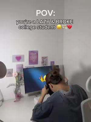 The cover image shows a college-aged female sitting at a desk with a computer, seemingly working. The text overlay reads 'POV: you're a LAZY & BROKE college student.' The background includes a wall with posters, and a vase of flowers.