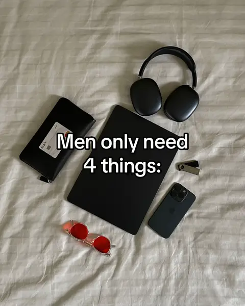 A top-down shot displays various items arranged on a wrinkled, off-white bedsheet. The items include a black wallet with a white card, a black tablet, red-tinted sunglasses, a smartphone, a pair of black headphones, and a small metal device. The text overlay 'Men only need 4 things:' is visible in the center.