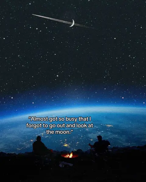 A serene nightscape featuring a vast, dark blue sky filled with stars, a crescent moon with a jet contrail passing overhead. Below, the Earth is visible with city lights and silhouetted figures of possibly two people sitting near a campfire.