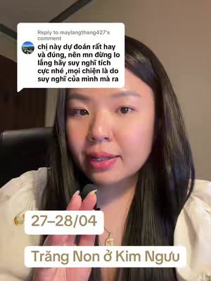 A medium shot of a young woman with dark hair and a white top is looking at the camera. The background appears to be indoors, possibly an office or living space. Text overlay includes the date and astrological information.