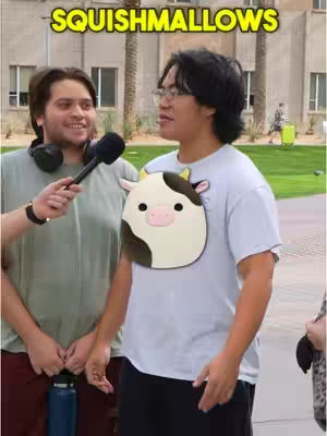 Two men are standing outdoors, one being interviewed and the other wearing a cow-shaped stuffed animal.