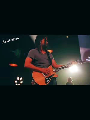 The cover image showcases a man playing an electric guitar on a stage. The image is primarily a medium shot, focusing on the musician with a dark background. The man is positioned centrally in the frame, actively engaged in playing the guitar. Soft lighting illuminates the stage, highlighting the man and his guitar.