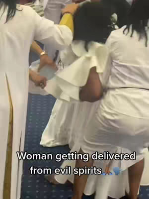 A scene inside what appears to be a church, with several people in white garments. A woman in the center is being supported by several people around her. The hook text at the bottom states the video's focus.