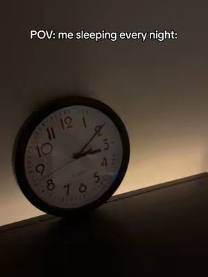 The cover image shows a wall clock with large black numerals. The clock is angled on a surface with a warm, ambient light shining to the right. The background is dark, creating a contrast with the clock face.