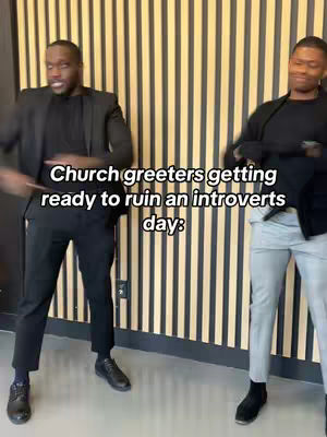 Two young men in suits standing in front of a patterned wall. Text overlay reads, 'Church greeters getting ready to ruin an introverts day'.