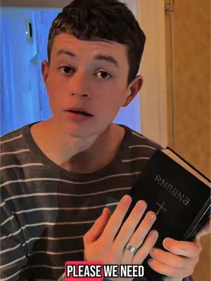 A young man looks towards the camera, holding a black book with the word "RNNA" visible, in front of a blurred background. At the bottom of the image, a red box reads, "PLEASE WE NEED". The man wears a grey striped shirt. The lighting is soft, and the overall effect suggests a call for religious support or discussion.