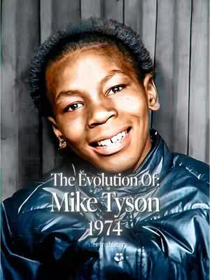 The cover image features a medium-close up of a young Mike Tyson smiling. The background is a blurred, textured gray-brown. Overlaid on the image are white texts that read 'The Evolution Of: Mike Tyson' and '1974' with a smaller text at the bottom.