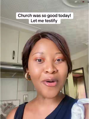 A woman with brown hair and wearing a black top is smiling and talking to the camera in a kitchen setting. There is text overlayed on the top of the image.
