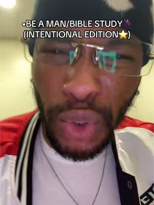 A close-up shot focuses on a man wearing glasses, a black beanie, and a white and red jacket. He is speaking directly to the camera, with text overlayed at the top.