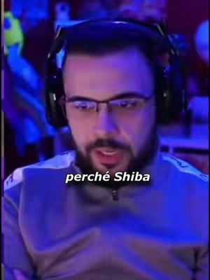 A close-up shot of a man with glasses and a beard wearing headphones. The background is blurred, suggesting a room with colored lights.