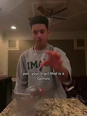 The cover image shows a man indoors, appearing to interact with something in front of him. He wears a light gray sweatshirt with the word "IMA" visible. Text overlayed on the image reads "pov: your a girl that is a Gemini." The background suggests a home-like setting.