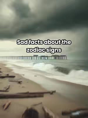 A dark, moody image of a beach with a pier extending into the sea under a cloudy sky. The beach is in the foreground with driftwood and scattered debris.
