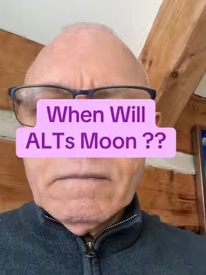 A close-up shot of a man wearing glasses, with a pink rectangle obscuring the center of his face. Wooden planks are visible behind the man's head.