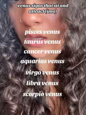 A close-up shot of a person with curly hair and a slightly visible face, with text overlays on the image. The person's skin is light-toned, and they have a nose ring. The text overlays are in white, listing various Venus signs.
