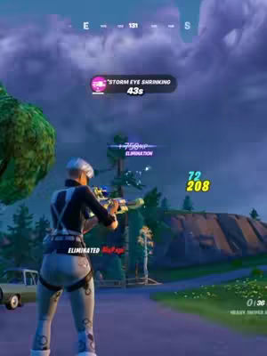 A screenshot from the video game Fortnite showing a character aiming down the sight of a weapon. The game's interface elements, such as the map, health, and time remaining, are visible. The background features a cloudy sky and a grassy landscape.