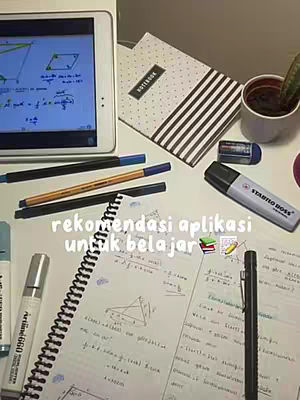 A top-down shot of a desk setup with various school supplies. A white tablet displaying a math problem dominates the upper left, while a notebook, pens, highlighters, and a small potted plant fill the rest of the frame. The color palette is bright and scholastic.