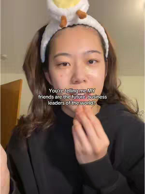 A woman with brown hair wearing a black top and a white headband with a yellow detail. Text overlay saying, "You're telling me MY friends are the future business leaders of the world?"