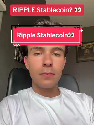 A selfie-style image features a man looking directly at the camera. Overlaying the man's forehead is a red rectangular text box that reads, "Ripple Stablecoin 👀". Above this box is another, smaller text box with the words with the words "RIPPLE Stablecoin? 👀". The man is wearing a white t-shirt, and the background includes a neutral wall and a glimpse of a picture frame on the right side of the shot. The lighting appears to be consistent.