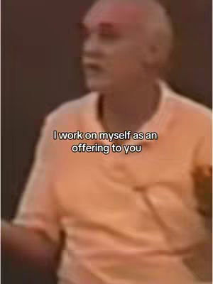 The image features a man speaking, with text overlaid on the frame. He appears to be in a casual setting, possibly a conference or informal talk. The background is blurred, focusing attention on the man and the message.